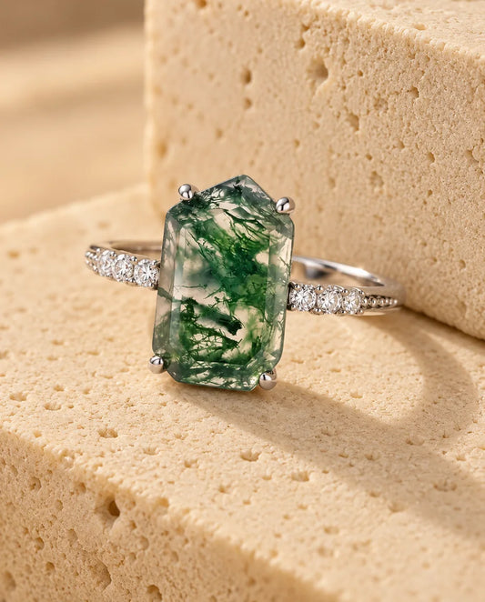 Emerald-Cut Moss Agate Ring - displayed on a travertine block