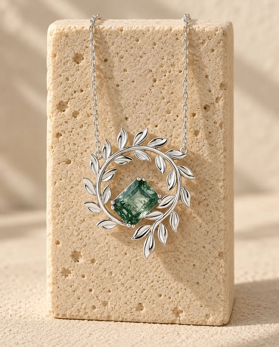 Moss Agate Necklace - displayed on a travertine block