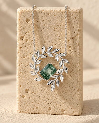 Moss Agate Necklace - displayed on a travertine block