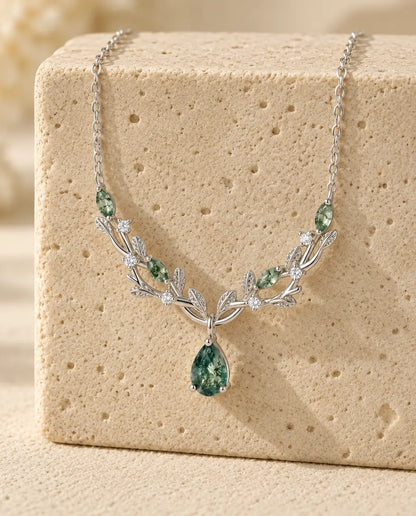 Moss Agate Necklace - displayed on a travertine block