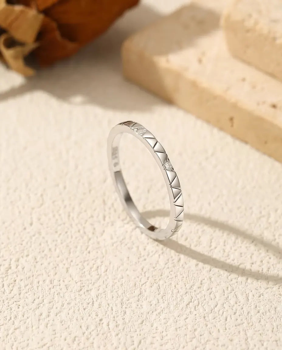 Moissanite Stacking Ring in 925 Sterling Silver - standing upright on a cream textured surface