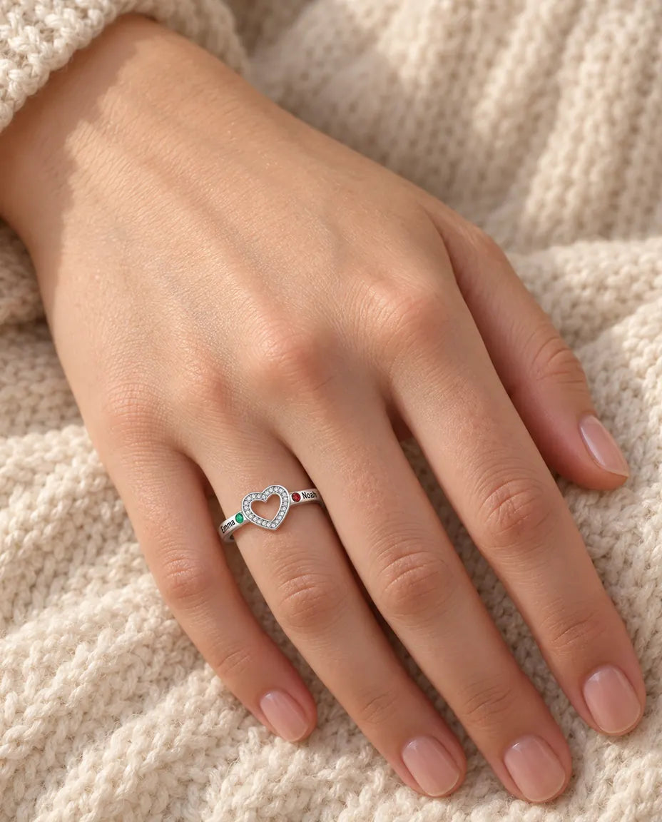 woman wearing personalized open heart birthstone ring with 2 engraved names on her ring finger