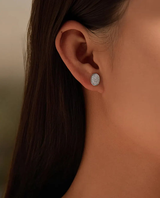 Oval Pave Moissanite Stud Earrings in 925 Sterling Silver - worn in the ear, close-up