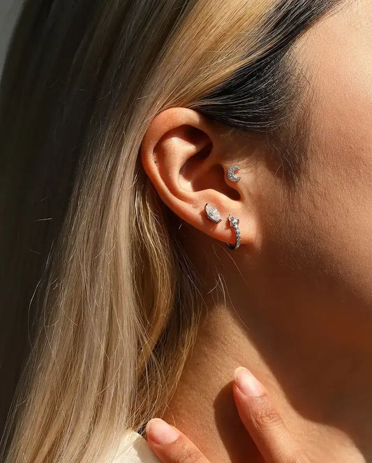 Pear Moissanite Huggie Hoop Earrings in 925 Sterling Silver - worn in the ear, close-up