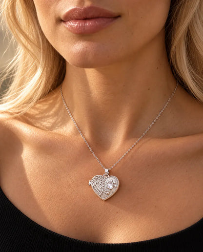 Woman in a black knit top wearing the silver tone angel wing paw print heart photo locket necklace