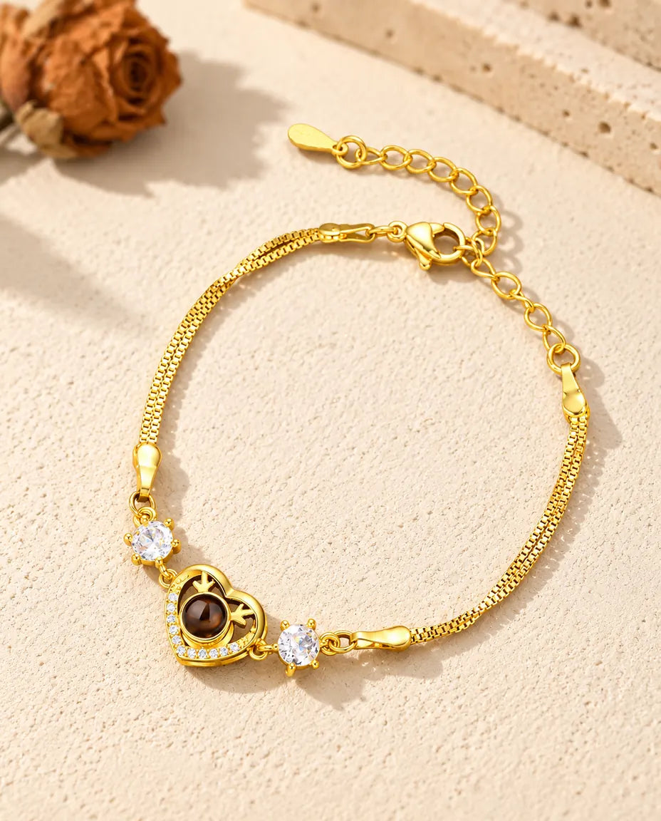 Gold tone heart charm bracelet with cubic zirconia, lobster clasp and extender chain