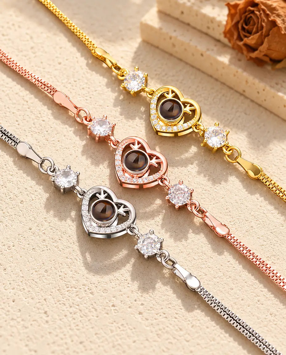 Close-up of three heart charms with tiny antlers and pave stones in each color