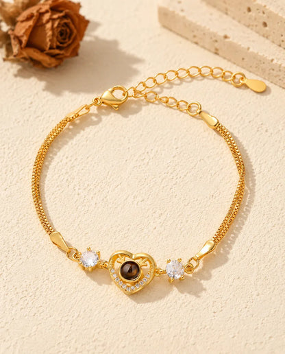 Top view of the gold tone antler heart photo projection bracelet with its extender chain