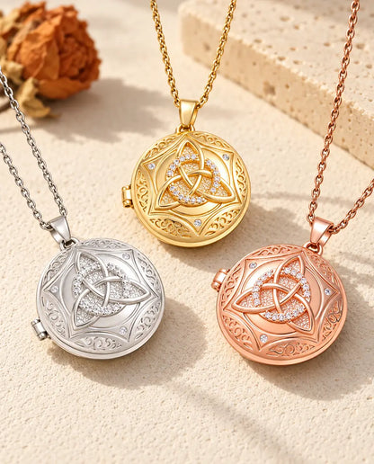 Three colors of the Celtic knot photo locket necklace arranged on plaster
