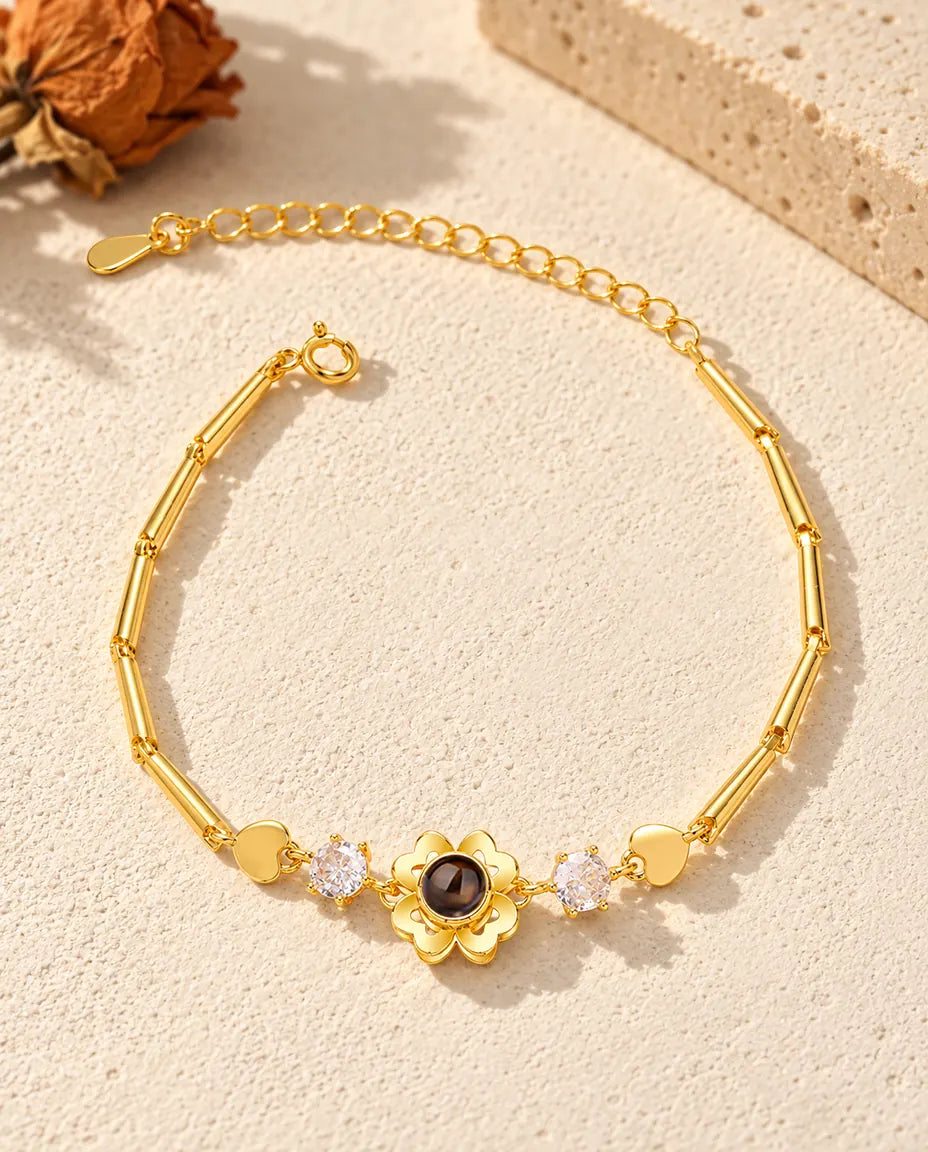 Top view of the gold tone clover flower photo projection bracelet