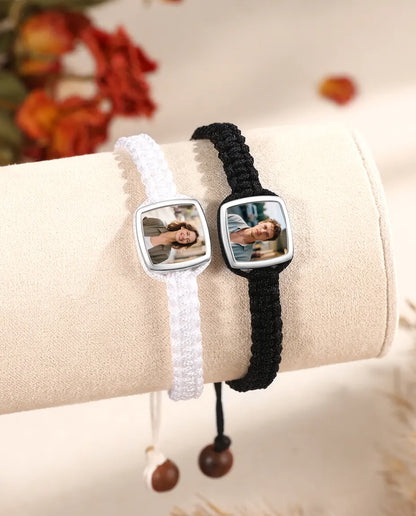 Black and white braided photo bracelets displayed side by side