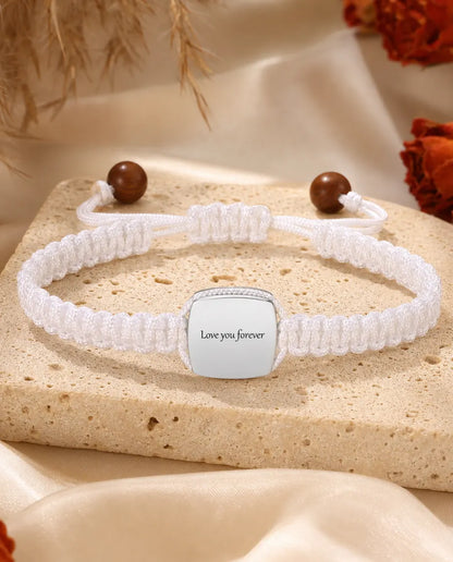 Back of the bracelet charm engraved with Love you forever in cursive