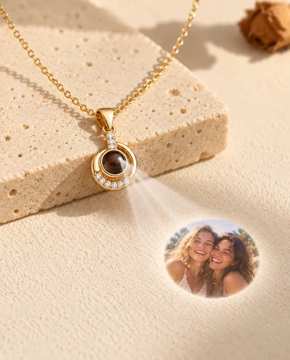 Gold tone crescent necklace projecting a photo of two best friends onto plaster