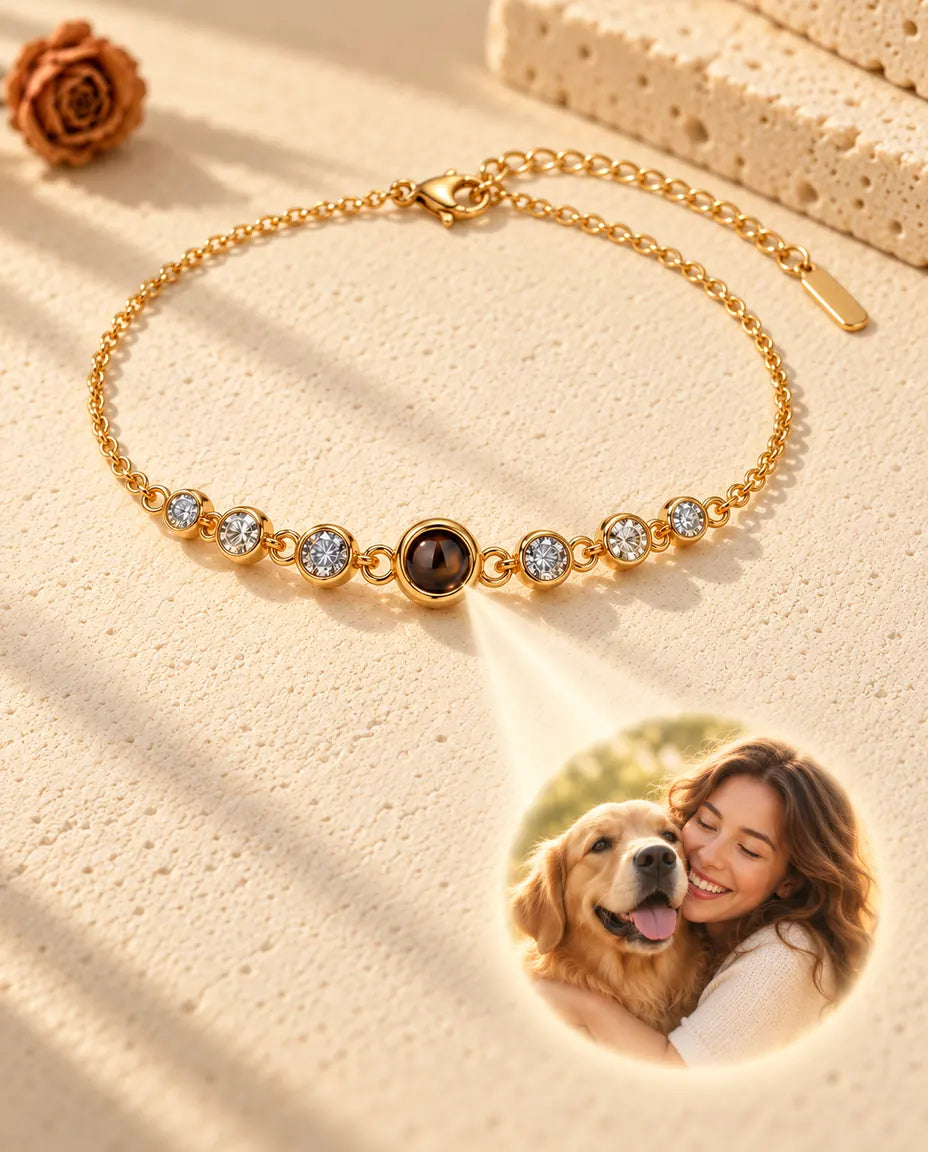 Light through the brown projection stone of the gold tone bracelet shows a round photo of a woman hugging her dog