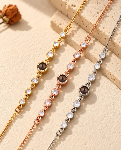 Three dainty stone bracelets in gold tone, rose gold tone and silver tone running side by side