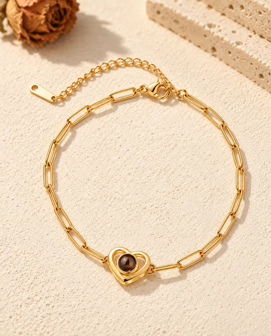 Top view of the gold tone double heart projection bracelet with its extender chain