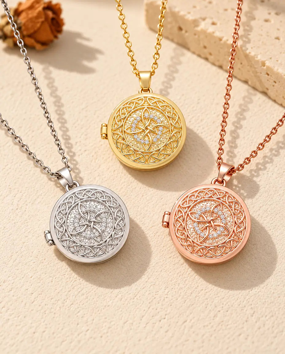 Three colors of the four-loop Celtic knot photo locket necklace arranged on plaster