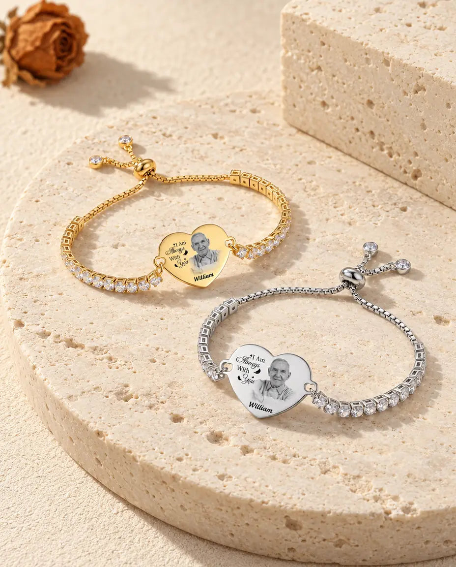 Silver tone and gold tone engraved photo heart bracelets together on travertine