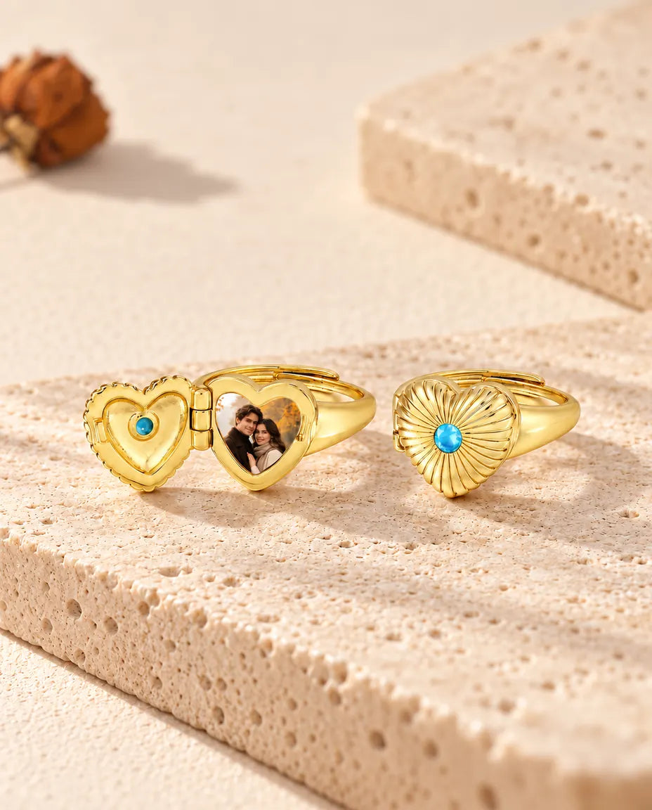 Two heart photo locket rings, one open with a photo and one closed