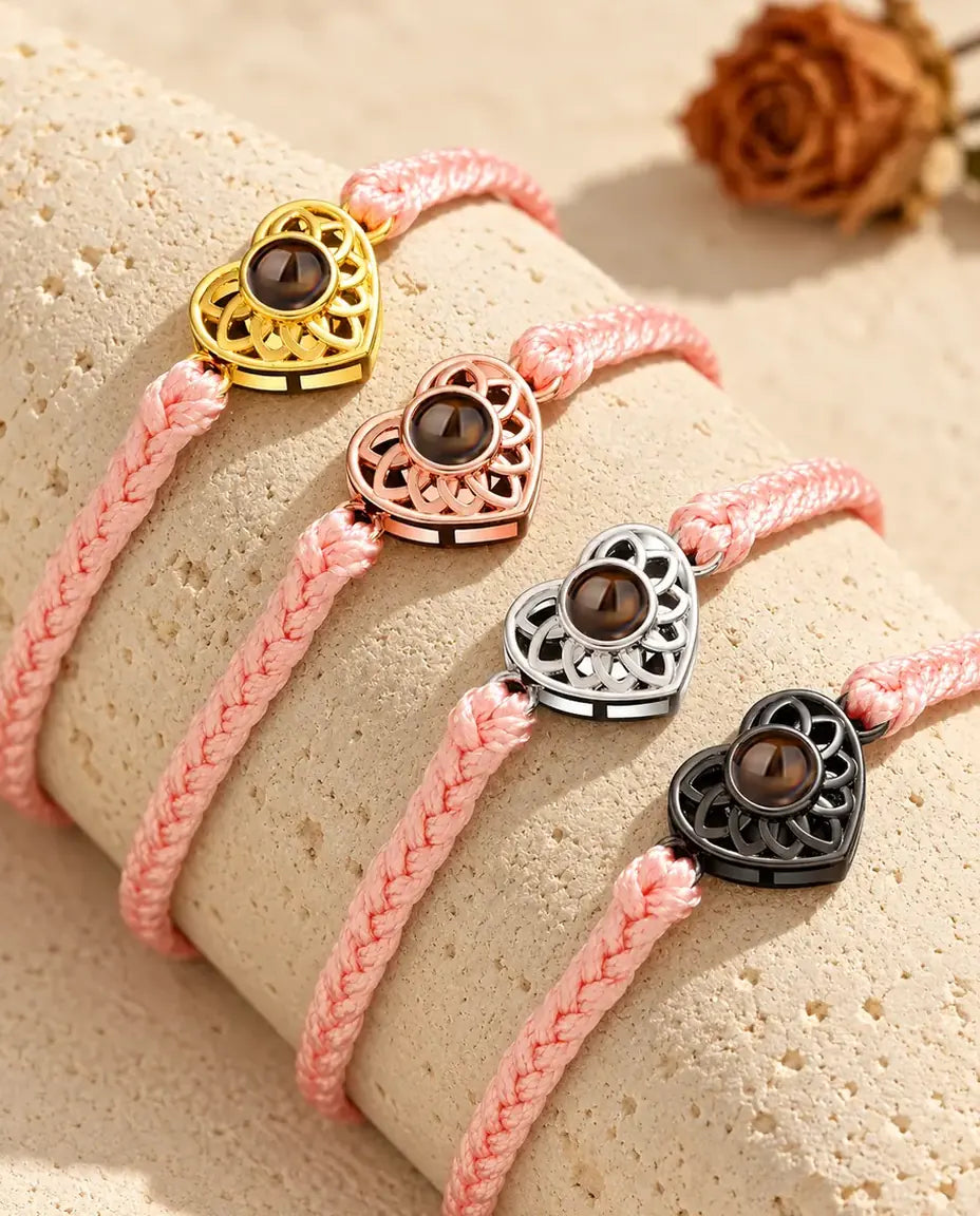 Pink thin braided cord projection bracelets with gold tone, rose gold tone, silver tone and black heart charms