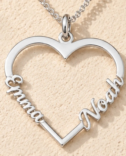 Personalized Heart Name Necklace in 925 Sterling Silver - Open Heart with Two Script Names - close-up of the cut-out name