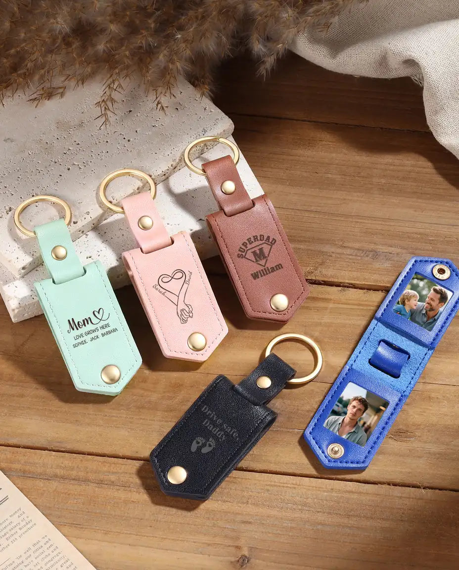 Personalized faux leather photo keychains in mint, pink, brown, blue and black with engraved fronts