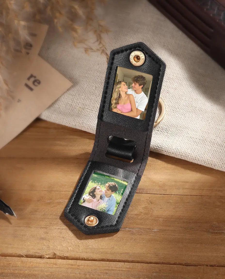 Black faux leather photo keychain open to show two custom pictures inside