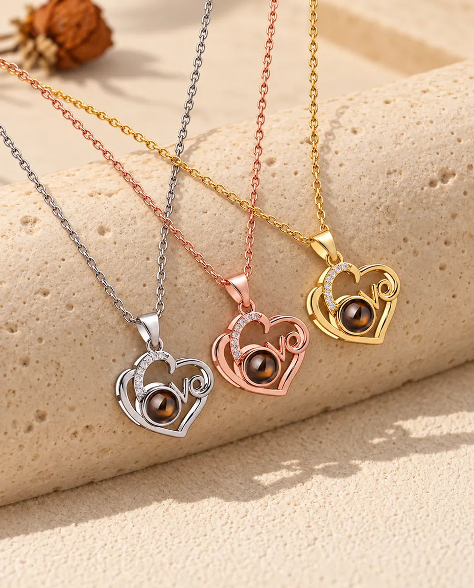 Three colors of the Love heart photo projection necklace in a row