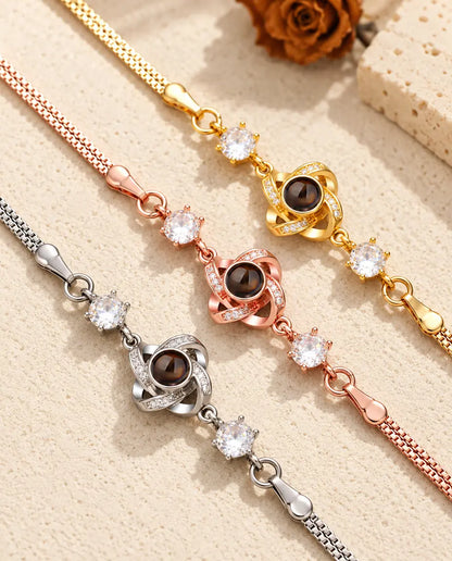 Close-up of three love knot charms with pave stones in each color
