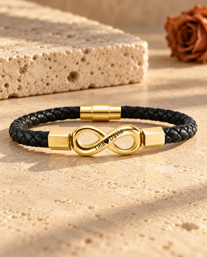 Gold tone engraved infinity bracelet for men on a black braided faux leather cord