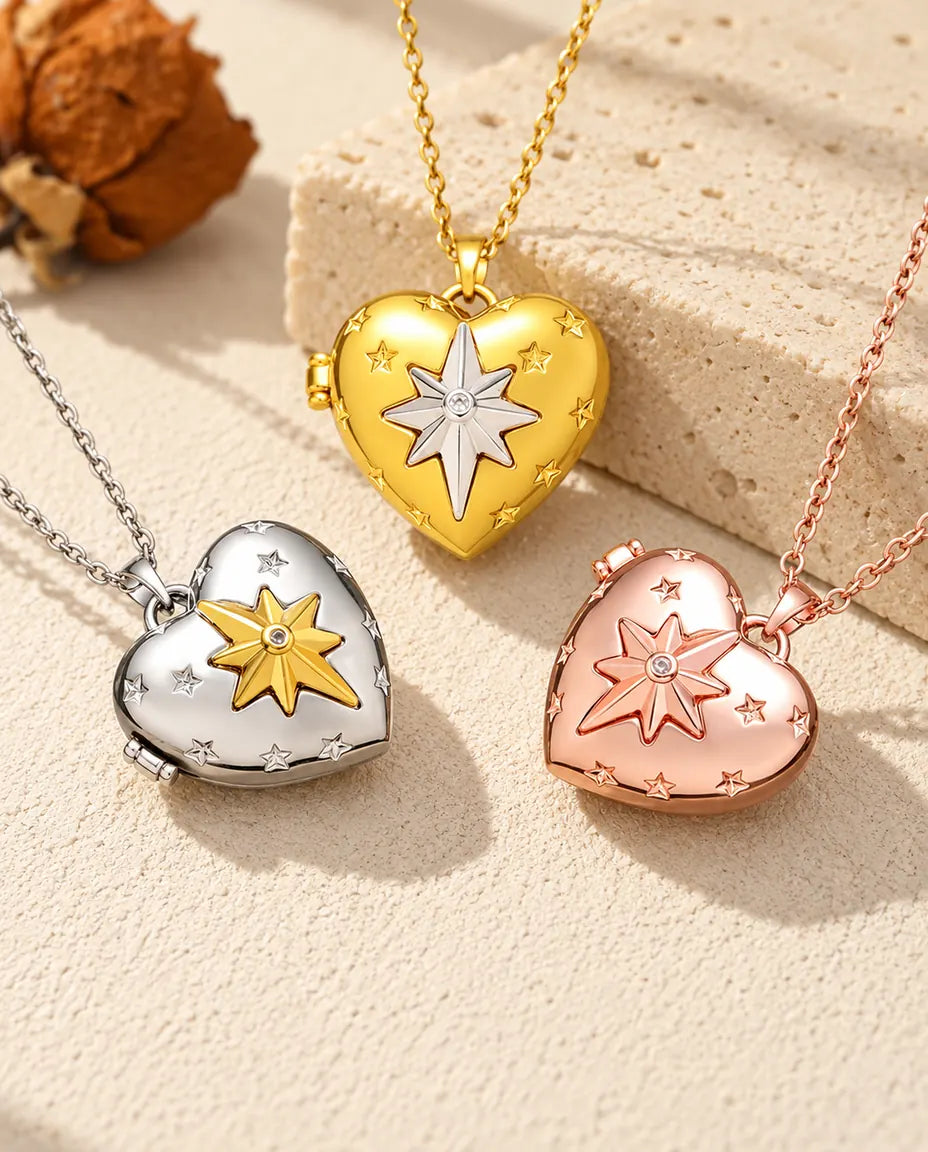 Three colors of the north star heart photo locket necklace arranged on plaster