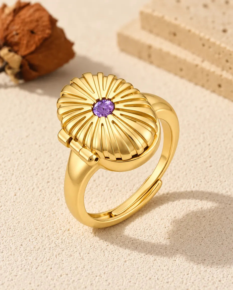 Personalized oval photo locket ring in gold tone with a purple birthstone on the fluted lid