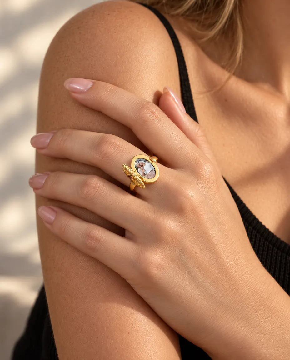 Woman wearing the oval locket ring open to show the photo inside