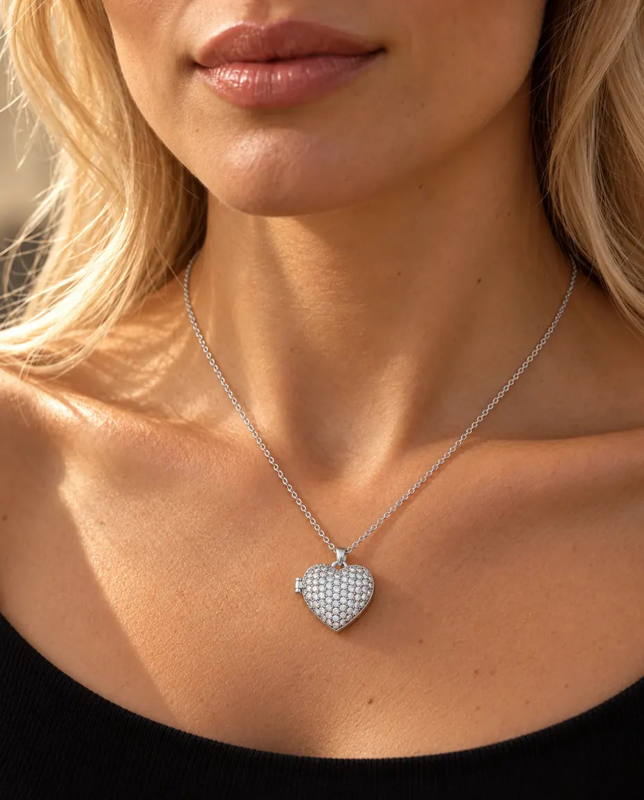 Woman in a black knit top wearing the silver tone pave heart photo locket necklace