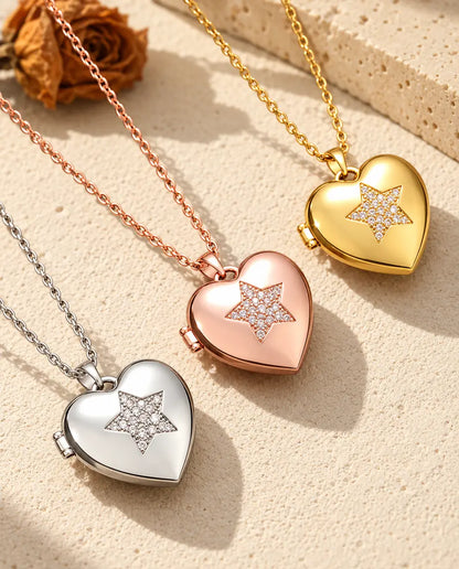 Pave star heart photo lockets in silver tone, rose gold tone and gold tone laid diagonally on cream plaster