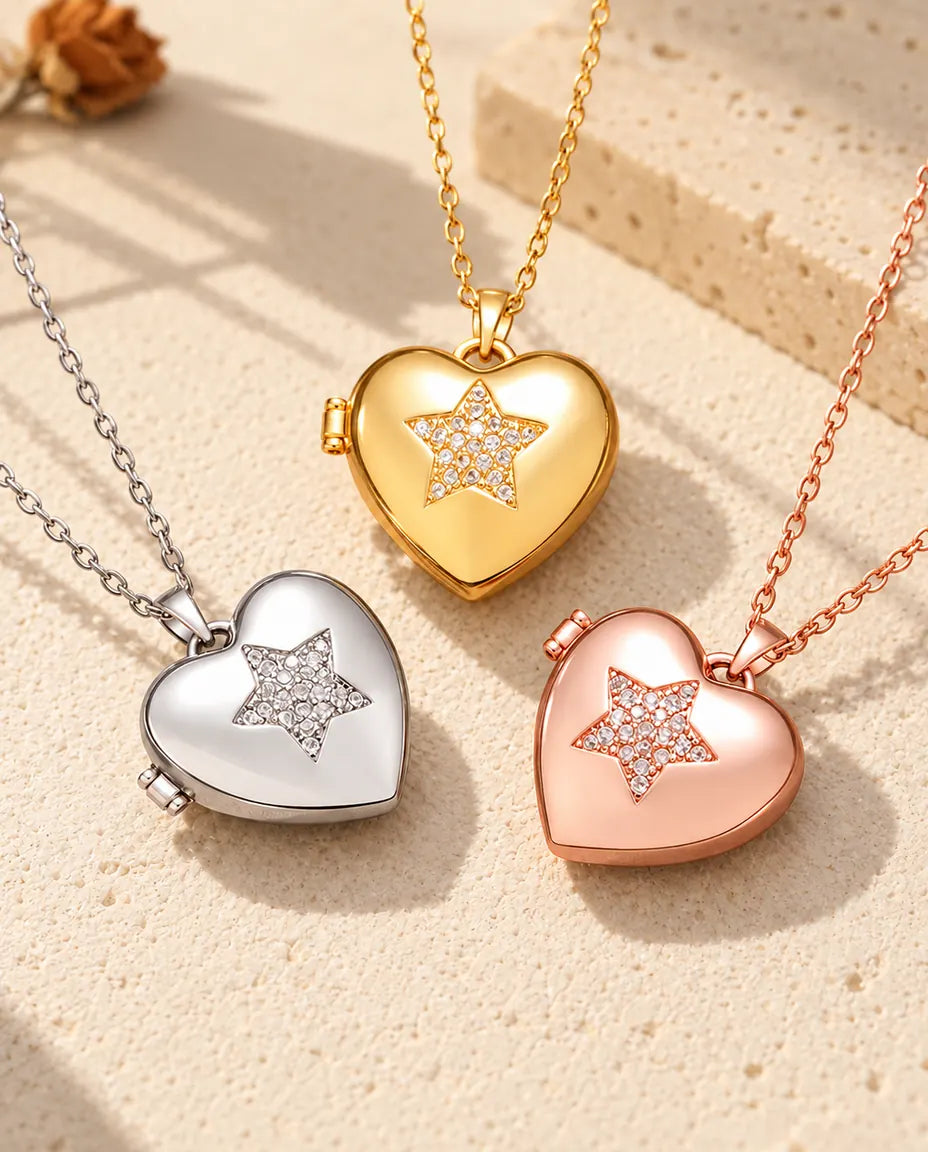 Three colors of the pave star heart photo locket necklace arranged on plaster