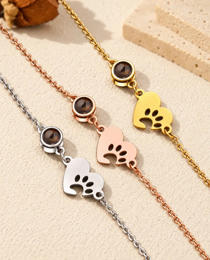 Close-up of three paw print heart tags and projection stones in each color