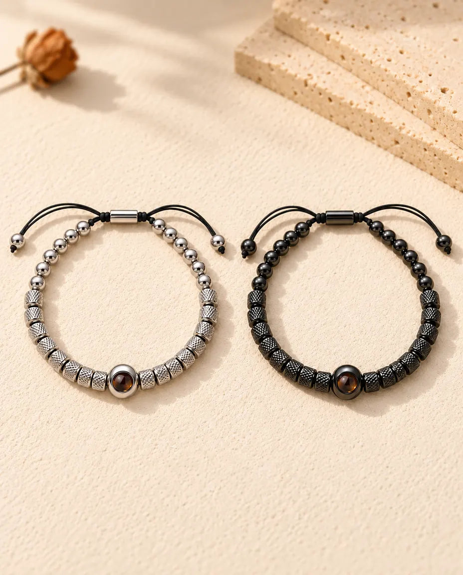Top view of the silver tone and black couples bead bracelets with sliders and cord ends
