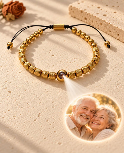 Light through the brown stone of the gold tone bead projects a round photo of an elderly couple