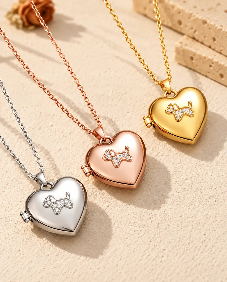Puppy heart photo lockets in silver tone, rose gold tone and gold tone laid diagonally on cream plaster