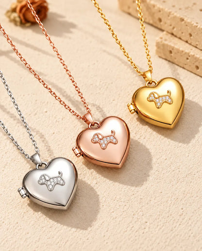 Puppy heart photo lockets in silver tone, rose gold tone and gold tone laid diagonally on cream plaster