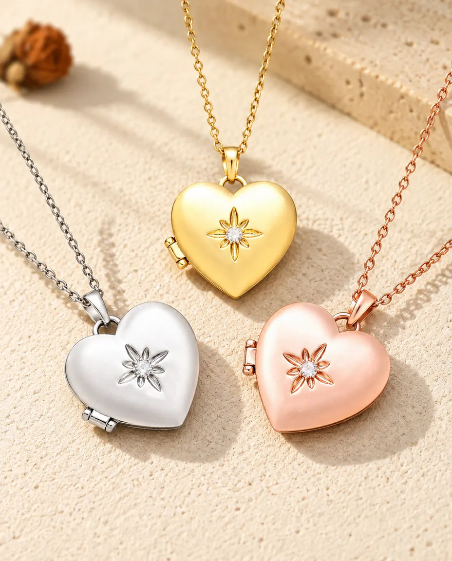 Three colors of the satin flower heart photo locket necklace arranged on plaster
