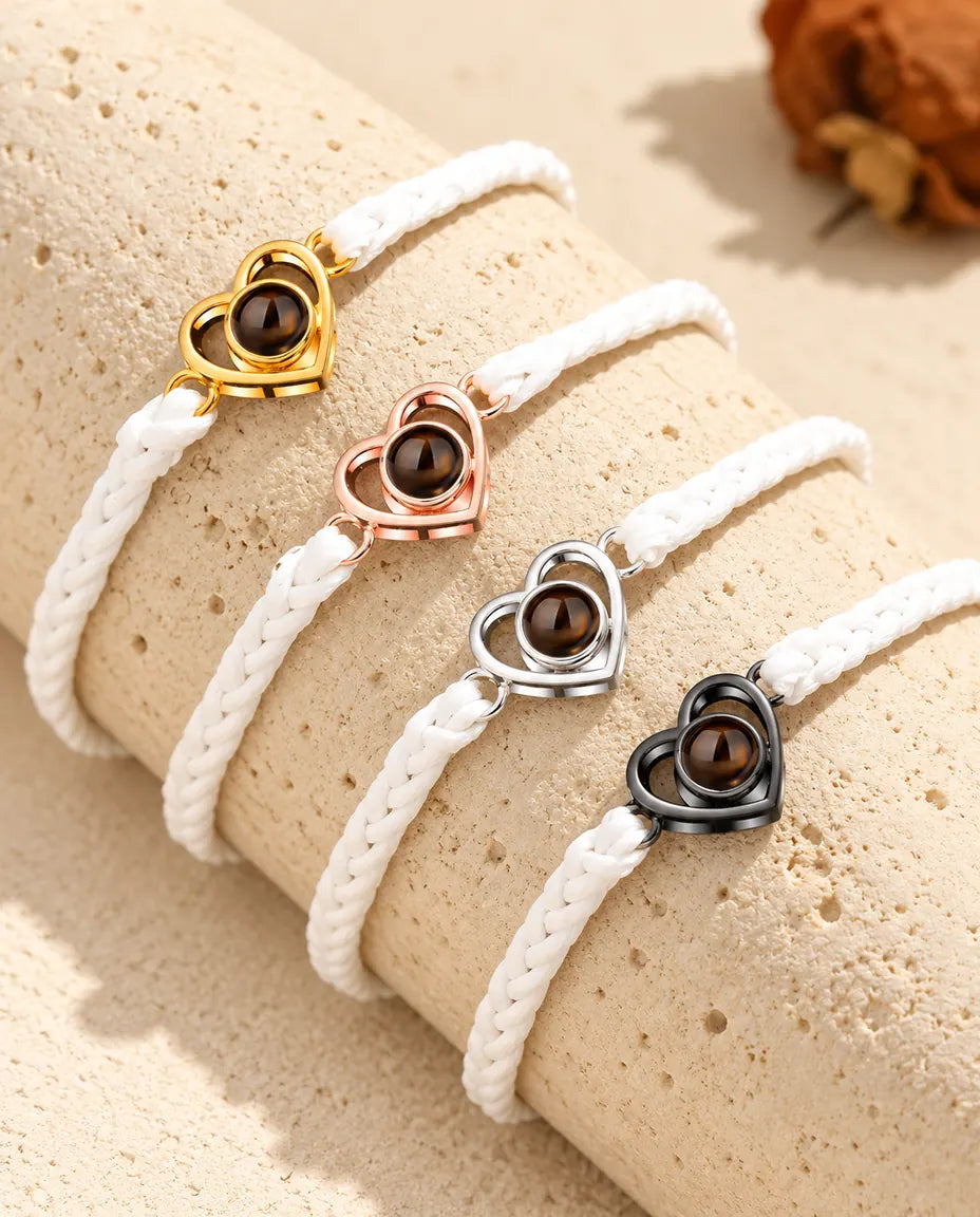 White braided cord open heart bracelets lined up in each charm color