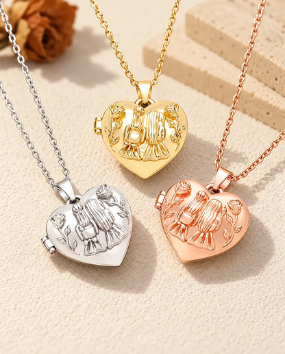 Three colors of the sisters heart photo locket necklace arranged on plaster