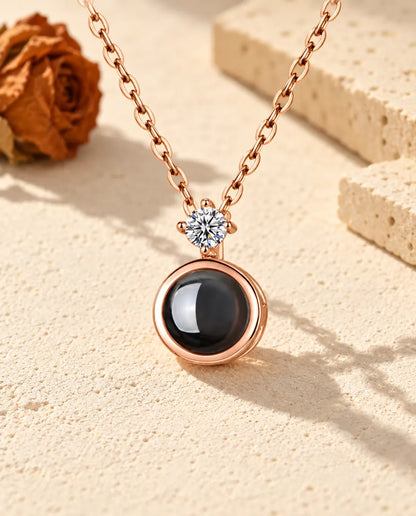 Personalized rose gold tone round photo projection necklace with a cubic zirconia solitaire