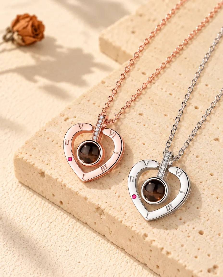Rose gold tone and silver Roman numeral heart necklaces laid diagonally on plaster