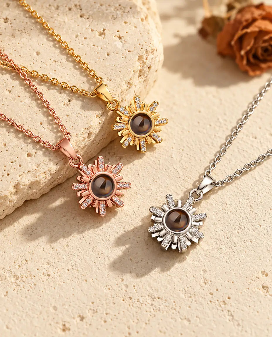 Sunburst projection necklaces in silver tone, gold tone and rose gold tone on travertine