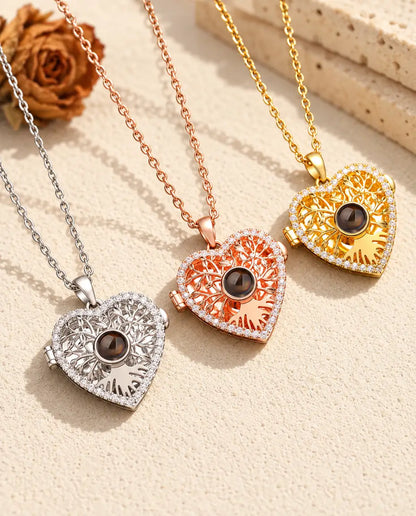 Three colors of the tree of life heart projection locket necklace side by side