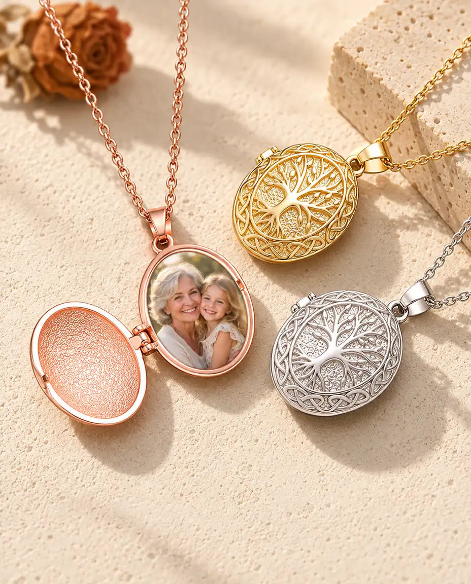 Rose gold tone tree of life locket opened to show a grandmother and granddaughter photo inside, beside closed gold tone and silver tone lockets