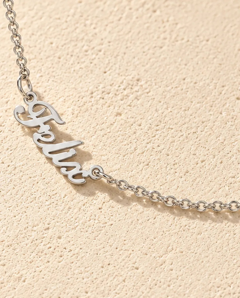 Personalized Two Name Necklace in 925 Sterling Silver - Two Script Nameplates Joined by Chain - close-up of the cut-out name